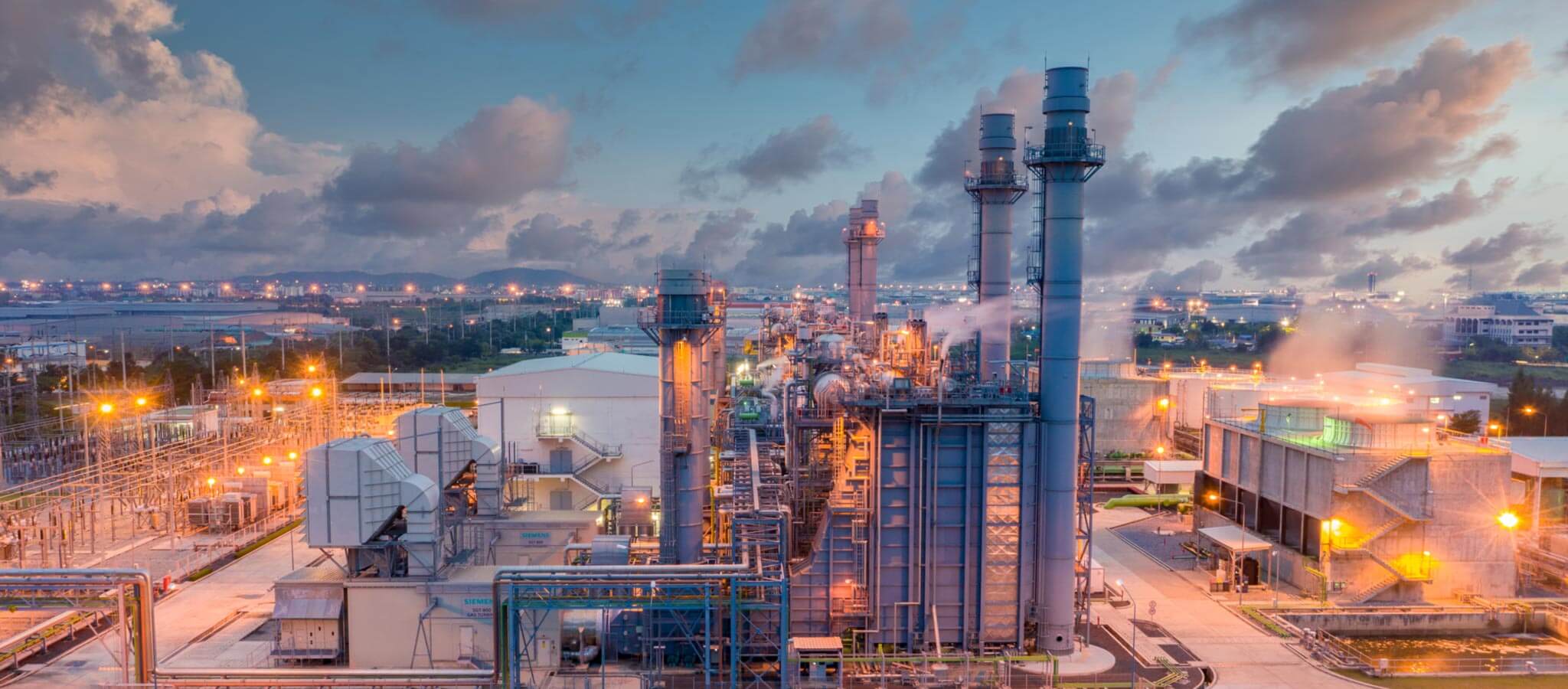 Wide shot of a power plant at dusk