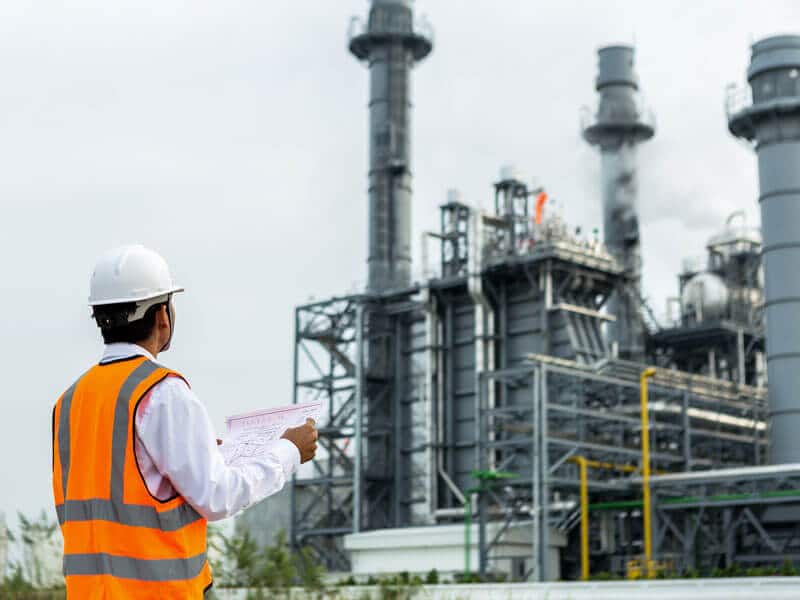 Engineer reviews paperwork outside power plant